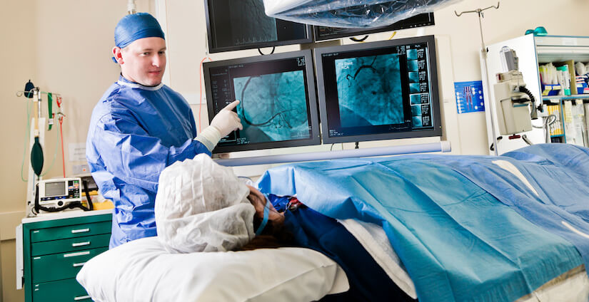 Cardiologist reviewing catheter procedure with patient